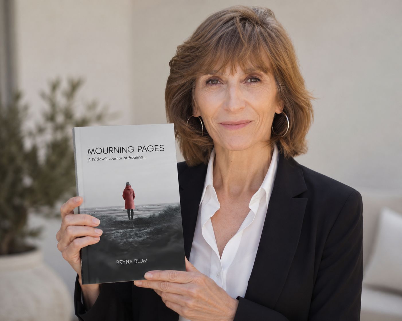 Bryna Blum holding her book Mourning Pages